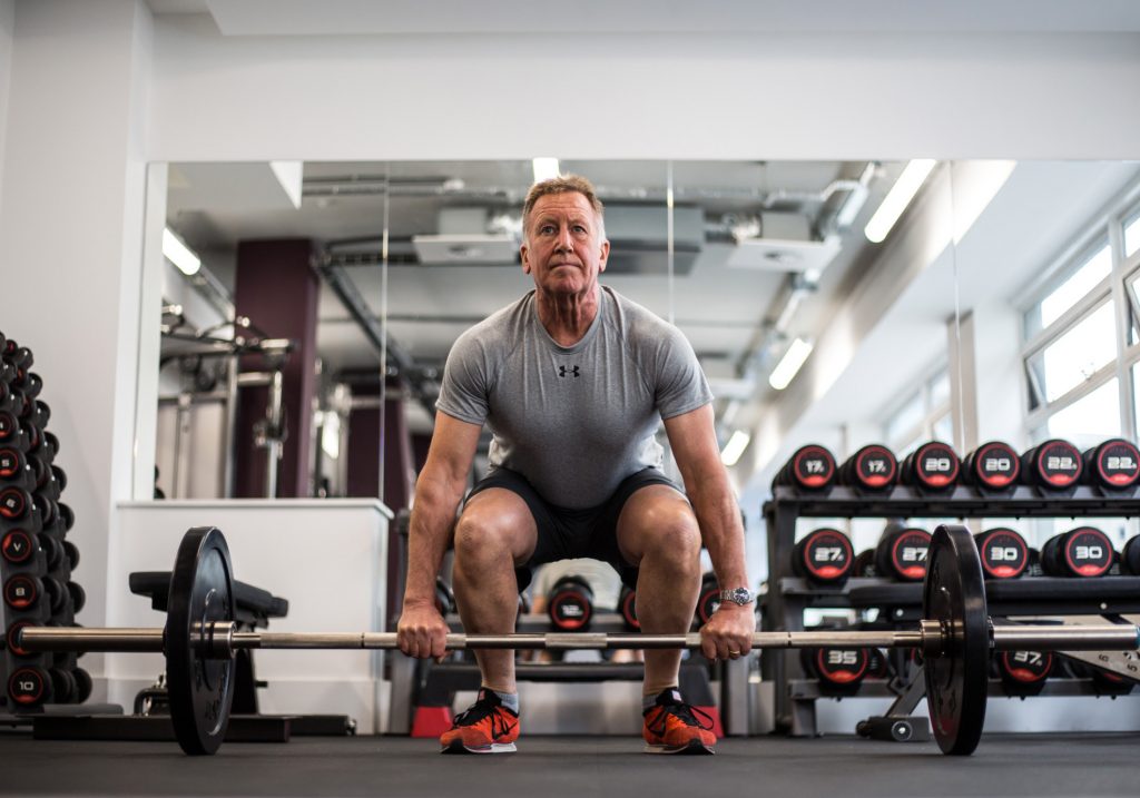 man strength training over 50